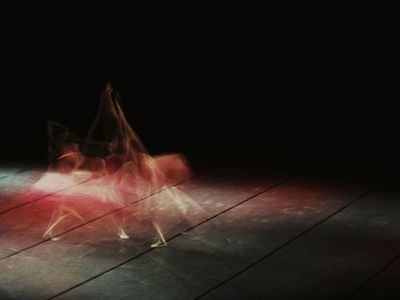 Blurry motion of a person performing a stretching move.